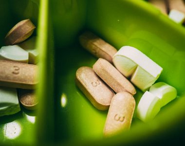 white medication pill on green plastic container